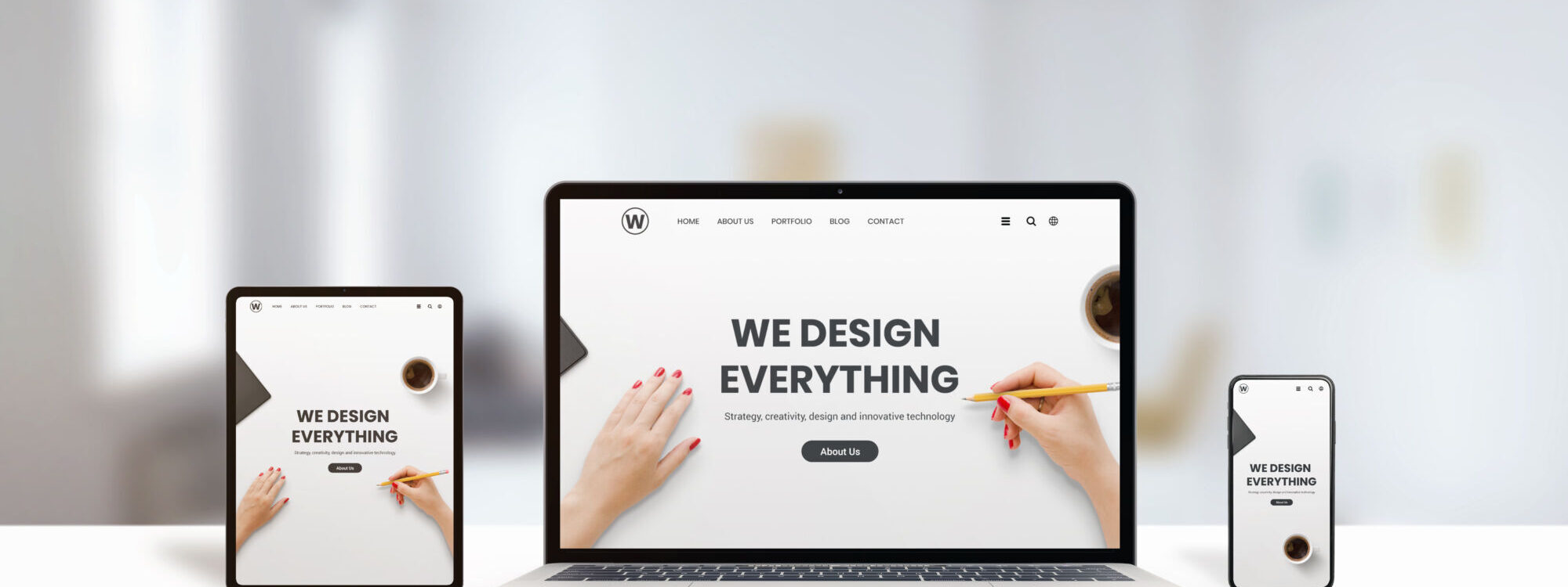 ADOBESTOCK_311145638 2000X750 | Cekome Appareils montrant un site web de design avec le slogan "WE DESIGN EVERYTHING", illustrant les services de conception web.
