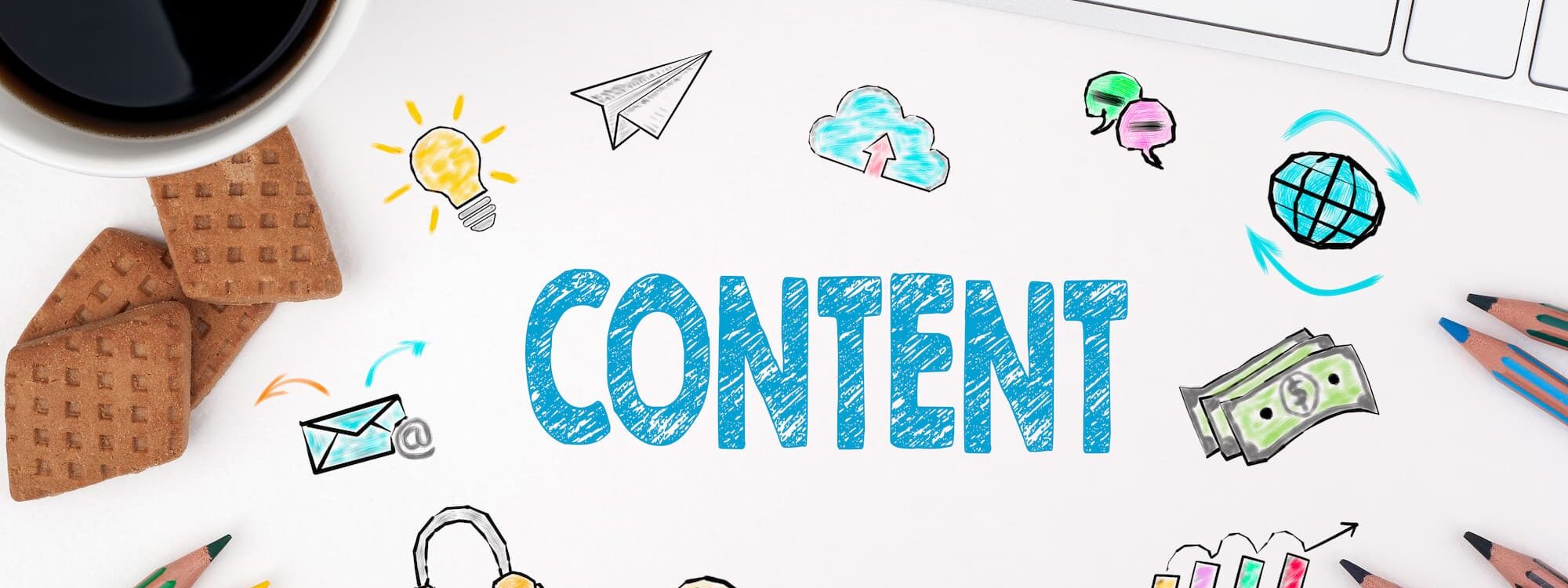 Planification de contenu avec divers symboles graphiques comme ampoule et enveloppe sur une table avec clavier et tasse de caf&eacute;.