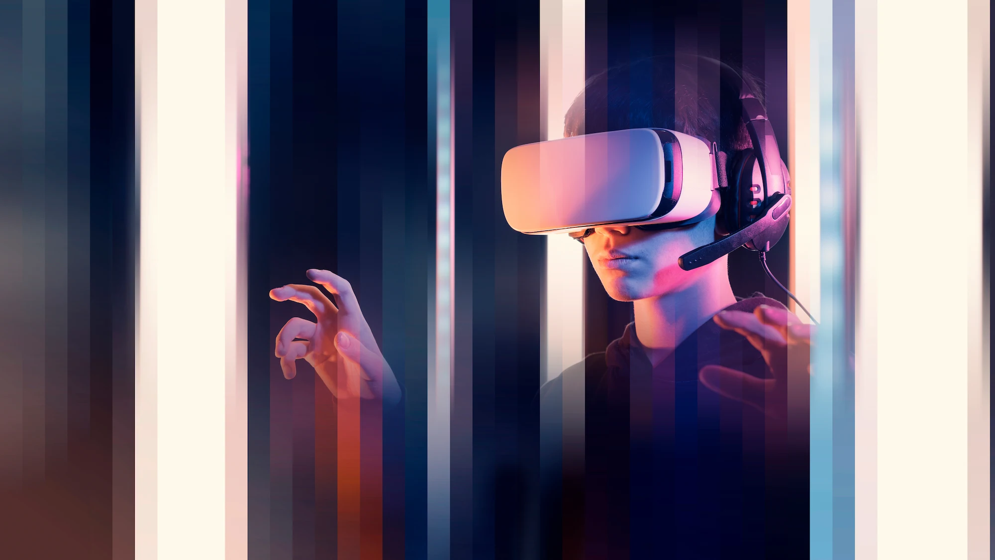 ADOBESTOCK_485983324 | Cekome Jeune homme portant un casque de réalité virtuelle et un micro-casque, immergé dans un univers numérique futuriste